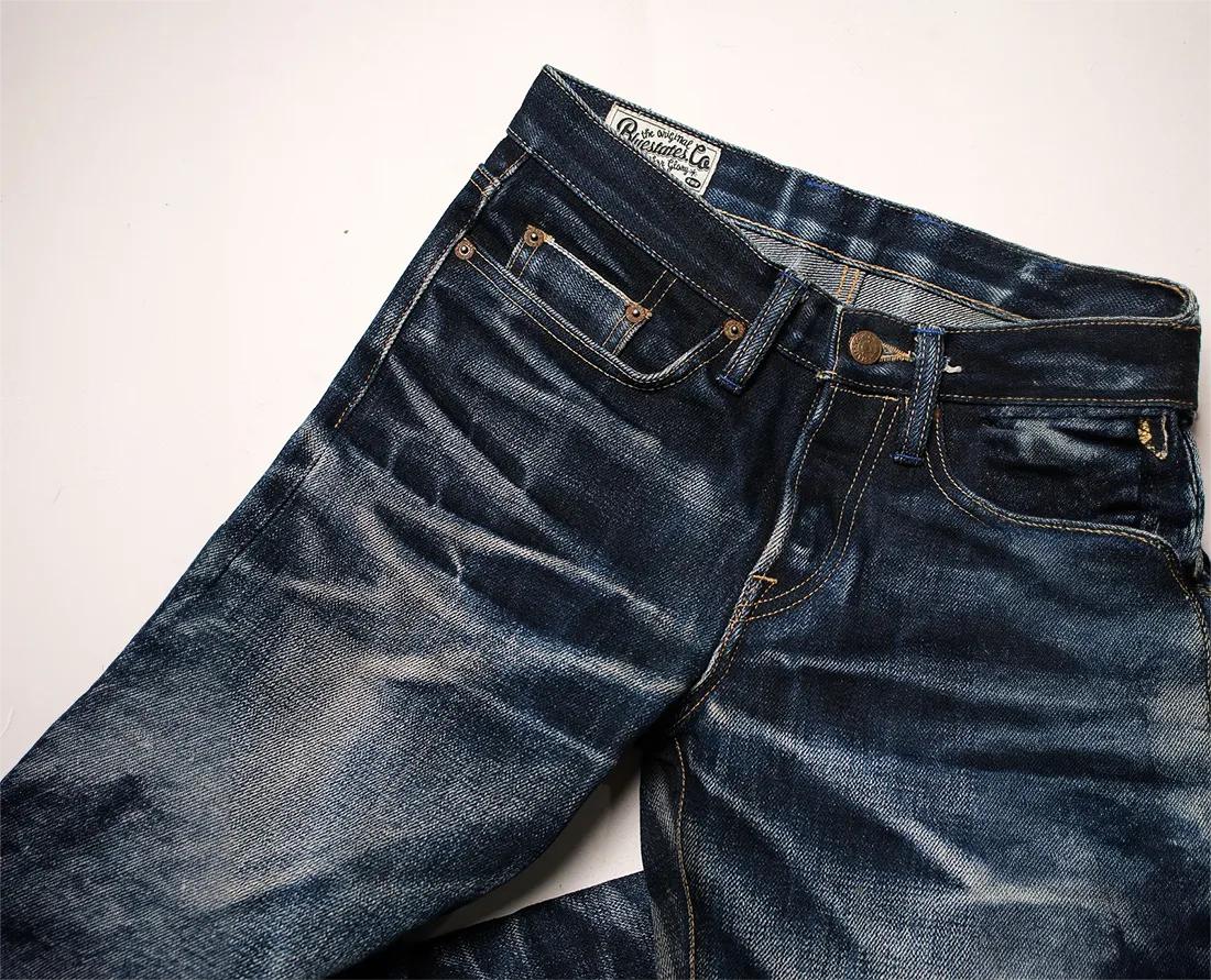 Hand-sanding a whisker onto raw denim