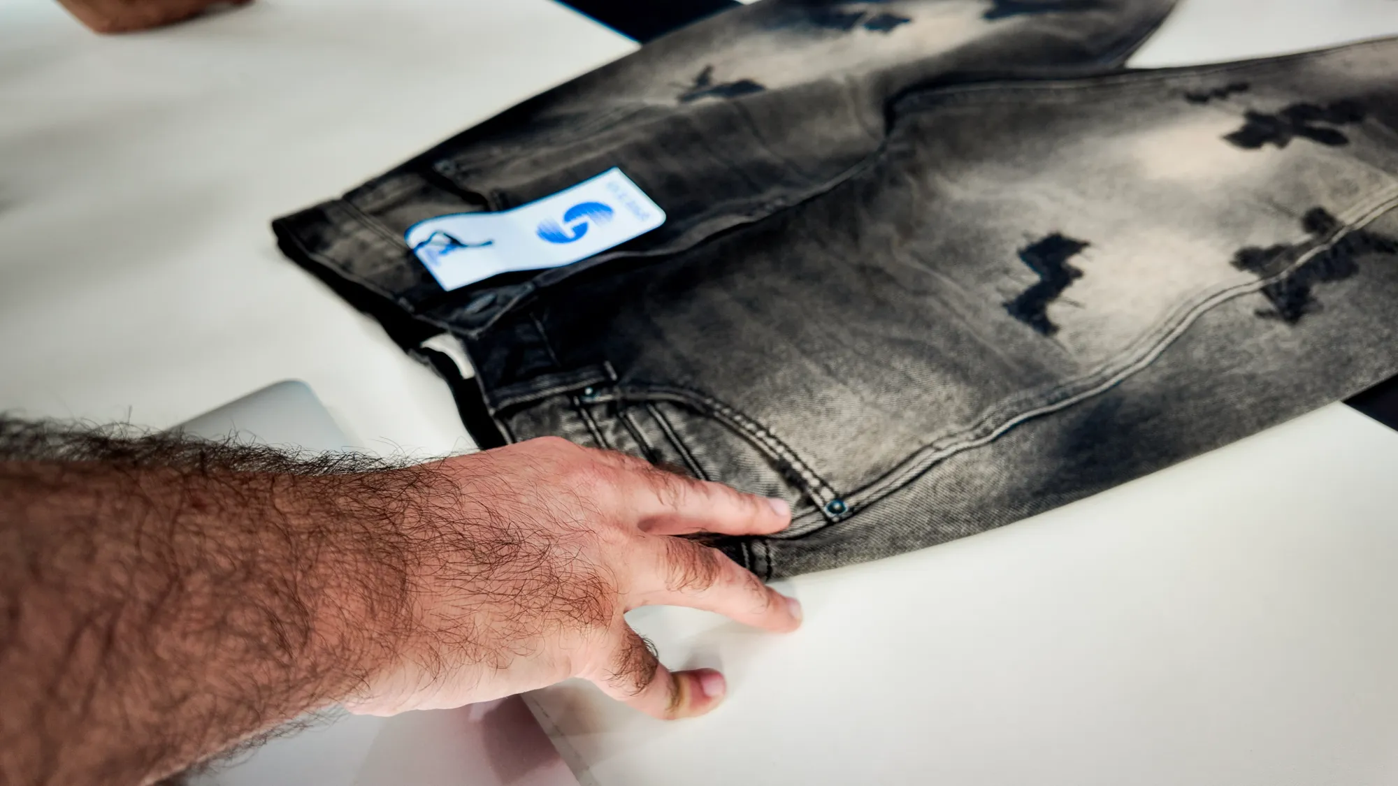 Team reviewing fabric swatches and tech packs